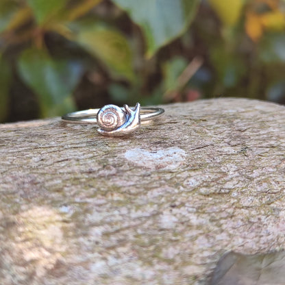  100% recycled silver stacking ring with a small, 3D Snail sitting on a log in front of ivy